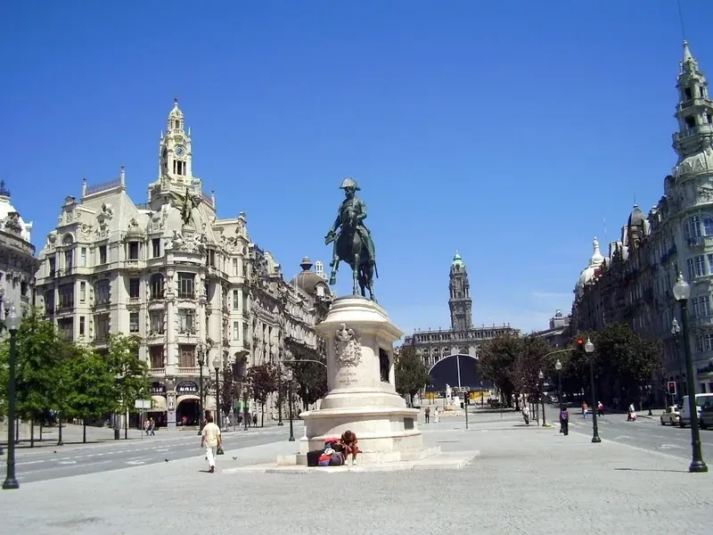 A wide avenue with an equestrian statue, lined with ornate buildings