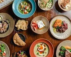 Overhead view of a table full of small sharing plates