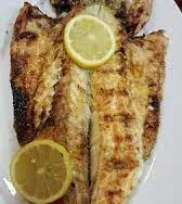 Grilled fish opened flat, with lemon slices