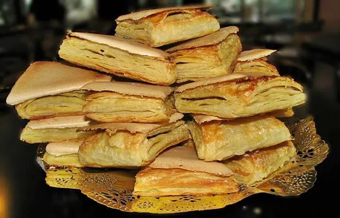 A stack of jesuítas, triangular puff pastries with a sugar glaze