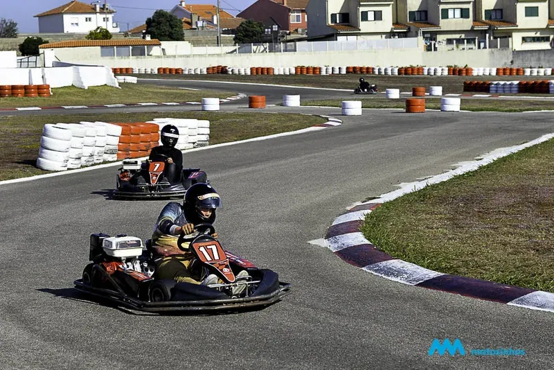 Two go-karts racing on an outdoor track