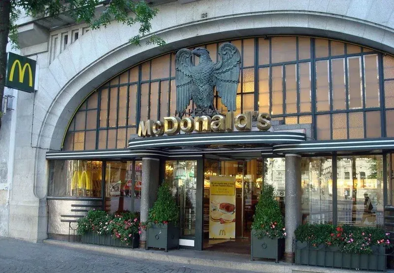 An Art Deco McDonald’s entrance, with a bronze eagle above the arched window