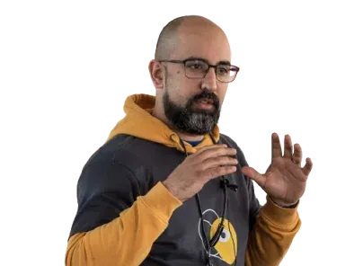 Pedro Vicente mid-talk, gesturing with both hands