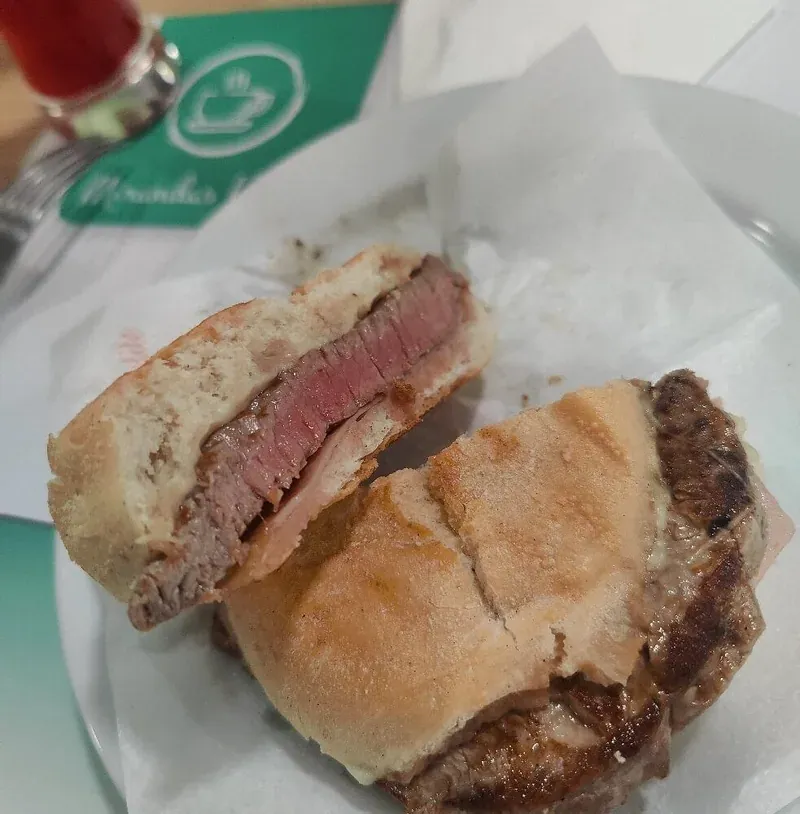 A prego: a pink-centred beef steak in a crusty bread roll