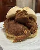 Rojões, chunks of fried pork, in a bread roll